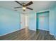 Bedroom with wood-look floors, closet, ceiling fan, and natural light from window at 5117 Cape Cod Dr, Holiday, FL 34690