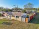 Charming exterior view of a single-story home with a fenced yard and well-kept landscaping at 5117 Cape Cod Dr, Holiday, FL 34690