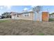 Home exterior showing a well-maintained lawn, and a combination wood and painted fence at 5117 Cape Cod Dr, Holiday, FL 34690