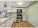 An updated kitchen featuring stainless steel appliances, white cabinets, and granite countertops at 5117 Cape Cod Dr, Holiday, FL 34690