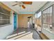 Cozy covered patio featuring textured walls, a ceiling fan, and access to the outdoors at 5117 Cape Cod Dr, Holiday, FL 34690