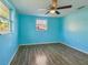 Room with wood-look floors and natural light from the surrounding windows at 5117 Cape Cod Dr, Holiday, FL 34690