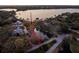 Waterfront property with a dock highlighted in red in an aerial view at 1011 Riverside Ridge Rd, Tarpon Springs, FL 34688