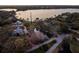 Expansive lakefront property with a pond, mature trees, and picturesque homes at 1011 Riverside Ridge Rd, Tarpon Springs, FL 34688