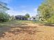 Large backyard featuring a screened-in porch, and mature landscaping at 1011 Riverside Ridge Rd, Tarpon Springs, FL 34688