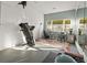 Finished basement area featuring a treadmill, desk, and mirror wall, ideal for home gym or office setup at 1011 Riverside Ridge Rd, Tarpon Springs, FL 34688