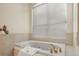 Close-up of a bathtub with a tiled surround and elegant fixtures at 1011 Riverside Ridge Rd, Tarpon Springs, FL 34688