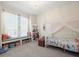 Cozy bedroom featuring a built-in window seat, canopy bed, plush decorations and carpeted floors at 1011 Riverside Ridge Rd, Tarpon Springs, FL 34688