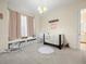 Cozy Bedroom featuring a crib, window seat, chandelier, and stylish decor, perfect for a new Gathering at 1011 Riverside Ridge Rd, Tarpon Springs, FL 34688