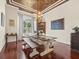 Inviting dining room with hardwood floors, a rustic table, and elegant chandelier lighting at 1011 Riverside Ridge Rd, Tarpon Springs, FL 34688
