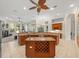 Spacious kitchen with wooden cabinets, granite countertops, and island with wine rack at 1011 Riverside Ridge Rd, Tarpon Springs, FL 34688