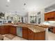 Open-concept kitchen with a large island, stainless steel appliances, and a view of the living room at 1011 Riverside Ridge Rd, Tarpon Springs, FL 34688