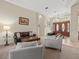 Bright and airy living room featuring a seating arrangement and views of the front entrance at 1011 Riverside Ridge Rd, Tarpon Springs, FL 34688