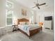 Bright main bedroom with a large bed, side tables, and a view of the bathroom at 1011 Riverside Ridge Rd, Tarpon Springs, FL 34688