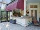 Outdoor kitchen features a built-in grill, bar seating, and a screened enclosure, perfect for entertaining at 1011 Riverside Ridge Rd, Tarpon Springs, FL 34688