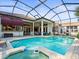Sparkling pool and spa surrounded by brick pavers and a screened enclosure offer ultimate relaxation at 1011 Riverside Ridge Rd, Tarpon Springs, FL 34688