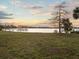 Lush waterfront property at sunset featuring a dock at 1011 Riverside Ridge Rd, Tarpon Springs, FL 34688