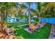 Inviting backyard featuring multiple benches, lush greenery, and decorative landscaping at 1011 W Columbus Dr, Tampa, FL 33602