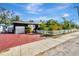 Exterior view of home featuring painted driveway, fenced yard, and attached garage at 1011 W Columbus Dr, Tampa, FL 33602