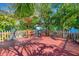 Cozy back patio with seating area, wood fence, and tropical landscaping at 1011 W Columbus Dr, Tampa, FL 33602