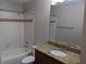 Bathroom featuring a shower-tub combo, granite counter, and updated vanity at 10200 Gandy N Blvd # 209, St Petersburg, FL 33702