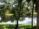 Serene pond view through lush trees offering a tranquil and picturesque setting at 10200 Gandy N Blvd # 209, St Petersburg, FL 33702