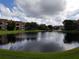 Scenic water view with community buildings, a tranquil fountain, and lush landscaping at 10200 Gandy N Blvd # 209, St Petersburg, FL 33702