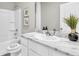 Bright bathroom featuring marble countertop and large mirror at 11842 Davis Dr, Largo, FL 33774