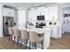 Bright kitchen with white cabinets, stainless steel appliances, large island, and pendant lighting at 12339 Hearts Ease St, Venice, FL 34293