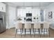Bright kitchen with white cabinets, stainless steel appliances, large island, and pendant lighting at 12339 Hearts Ease St, Venice, FL 34293