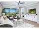 Bright living room with sliding glass doors to lanai, white sofa, and decorative rug at 12339 Hearts Ease St, Venice, FL 34293