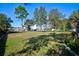 Spacious backyard area with mature trees and landscaped edges, offering ample outdoor space for recreation at 13255 Don Loop, Spring Hill, FL 34609