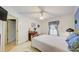 Bright bedroom with white furniture, blue accents, and a ceiling fan; offers a peaceful retreat at 13255 Don Loop, Spring Hill, FL 34609