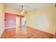 Large bedroom with hardwood floors, a ceiling fan, and neutral wall colors at 13255 Don Loop, Spring Hill, FL 34609