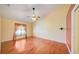 Spacious bedroom with hardwood floors, a ceiling fan, and natural light from the window at 13255 Don Loop, Spring Hill, FL 34609