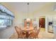 Bright breakfast nook with wooden table set and sunlit window; ideal for casual dining at 13255 Don Loop, Spring Hill, FL 34609