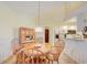 Bright breakfast nook with wooden table and chairs, adjacent to a kitchen with ample natural light at 13255 Don Loop, Spring Hill, FL 34609
