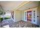 Charming porch area with brick pavers, a glass-paneled front door, and views of the front yard at 13255 Don Loop, Spring Hill, FL 34609