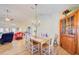 Open-concept dining room with chandelier, wood floors, and natural light at 13255 Don Loop, Spring Hill, FL 34609