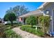 Inviting home exterior with a brick pathway, manicured bushes, and a small covered porch area at 13255 Don Loop, Spring Hill, FL 34609