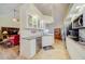 Bright kitchen features white cabinetry, granite countertops, modern appliances and tiled floors at 13255 Don Loop, Spring Hill, FL 34609
