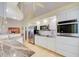 Modern kitchen with stainless steel appliances, granite counters, and white cabinetry offering ample storage space at 13255 Don Loop, Spring Hill, FL 34609