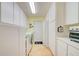 Well-organized laundry room with appliances, storage cabinets, and countertop space; bright and functional at 13255 Don Loop, Spring Hill, FL 34609