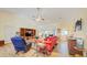 Bright living room with hardwood floors, ceiling fan, large windows, and plenty of seating at 13255 Don Loop, Spring Hill, FL 34609