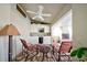 Relaxing outdoor patio featuring a fireplace, grilling area and a ceiling fan at 13255 Don Loop, Spring Hill, FL 34609