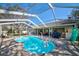 Enjoy this screened-in pool with a paver deck, surrounded by outdoor seating for relaxing and entertaining at 13255 Don Loop, Spring Hill, FL 34609