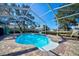 Screened-in pool area with brick-paved deck and lounge chairs, perfect for outdoor relaxation at 13255 Don Loop, Spring Hill, FL 34609