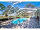 Sparkling pool in a screened enclosure with brick patio and basketball hoop at 13255 Don Loop, Spring Hill, FL 34609