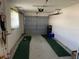 An empty garage space with a gray door and room for storage at 14132 89Th Ave, Seminole, FL 33776