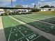 Well-maintained shuffleboard courts in a recreational area with covered seating at 14132 89Th Ave, Seminole, FL 33776